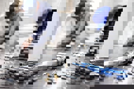 a plumbing technician doing a toilet repair