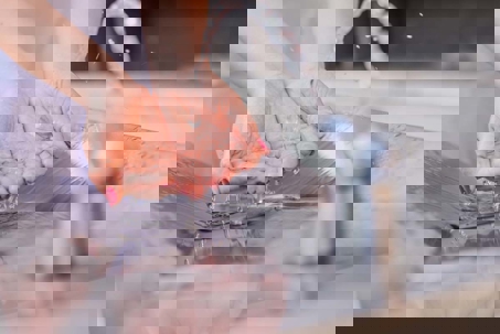 a woman washing her hands in the faucet