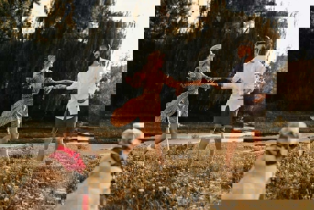 a couple is dancing with their dog