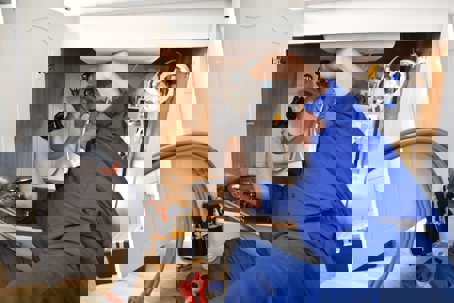 a plumber repairing the pipes