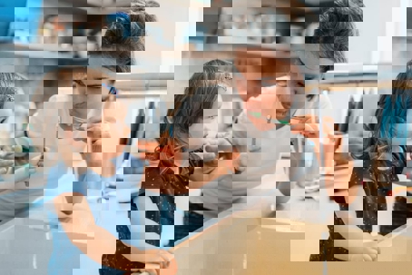 a mother and daughter was toothbrushing