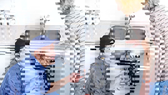 a professional plumbing technician doing an inspection